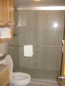 Standing shower with sliding glass door