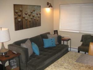 Condo living room with couch and wall art