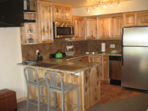 Condo kitchen with bar chairs