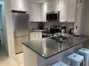 Kitchen with white wood cabinets