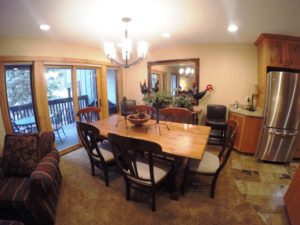 Fisheye dining room shot with recliner and fridge view