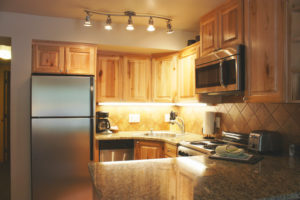 Condo kitchen with overhead lighting