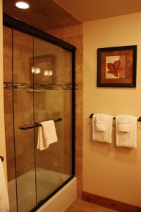 Bathroom with glass shower doors and towel rack