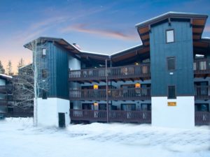 Exterior view of Vail Racquet Club Condos with snow