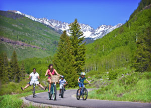 Family of 4 biking on path