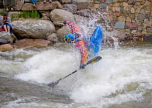Guy kayaking in raging river