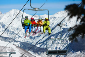 Friends sitting on ski lift