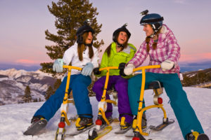 Friends sitting on ski bikes