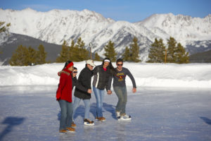 Group of friends on frozen pond ice skating