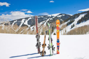 Skis propped in snow in front of mountain view