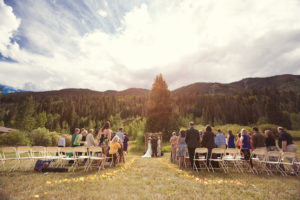 Alternate shot of wedding reception in field with bicycle