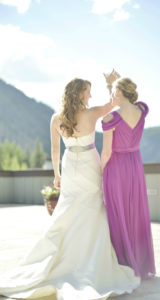 Bride and Bridesmaid posing on deck with mountain view