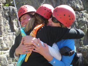 Rock climbers hugging
