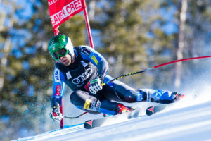 Ski racer taking gate in giant slope
