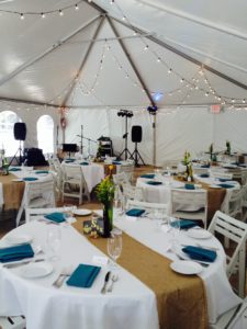 Wedding reception under tent with blue napkins
