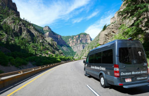 Colorado Mountain Express van driving down road