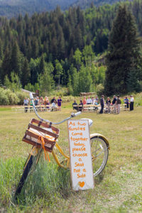 Wedding reception in field with close up of bicycle