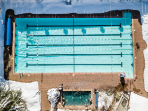 Aerial view of outdoor lap pool with nearby snow