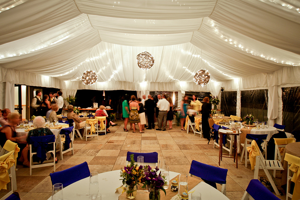 Wedding reception party at night under tent