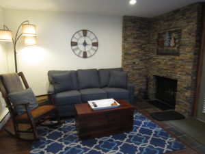 Sofa and rocking chair in front of fireplace
