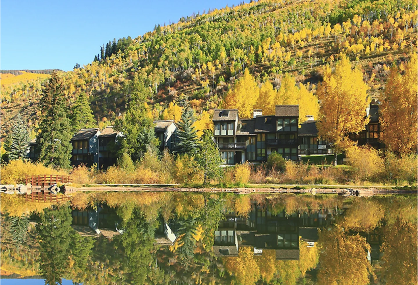 a large building surrounded by trees and a lake